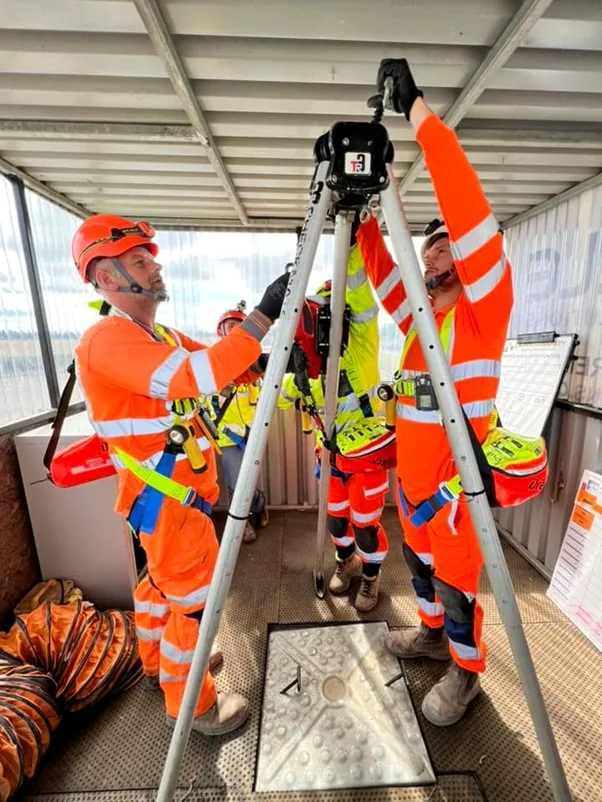Workers preparing rescue and access equipment for confined-space training