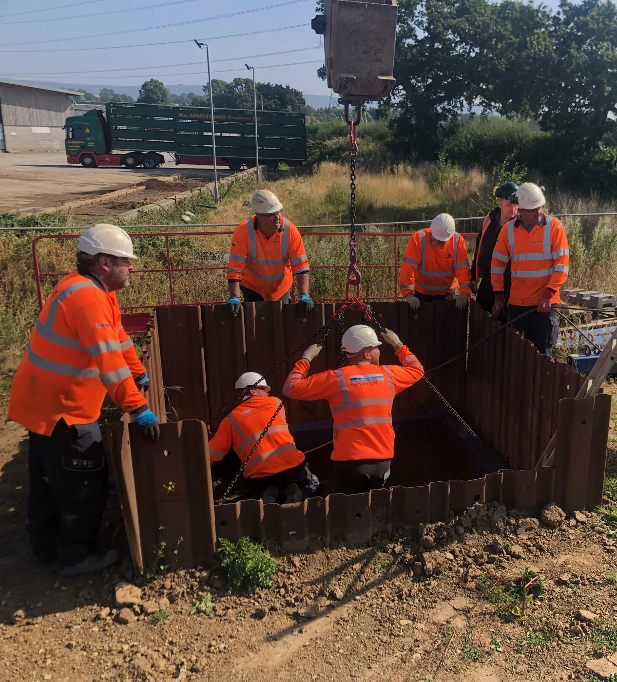 Construction workers undertaking a practical trench support installation