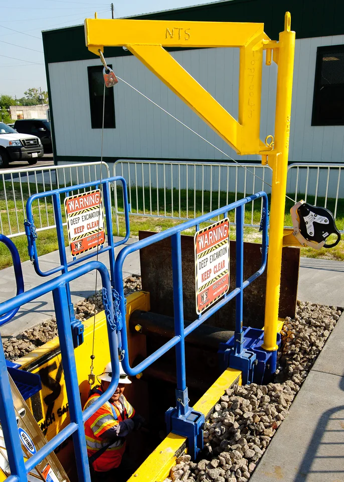 Worker using guarded access equipment on an elevated work platform